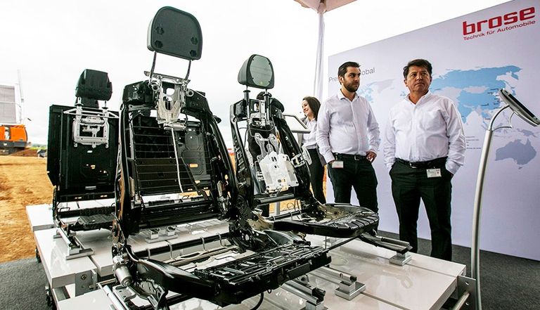 Brose automotive seat frames displayed under a tent during the groundbreaking ceremony for its plant