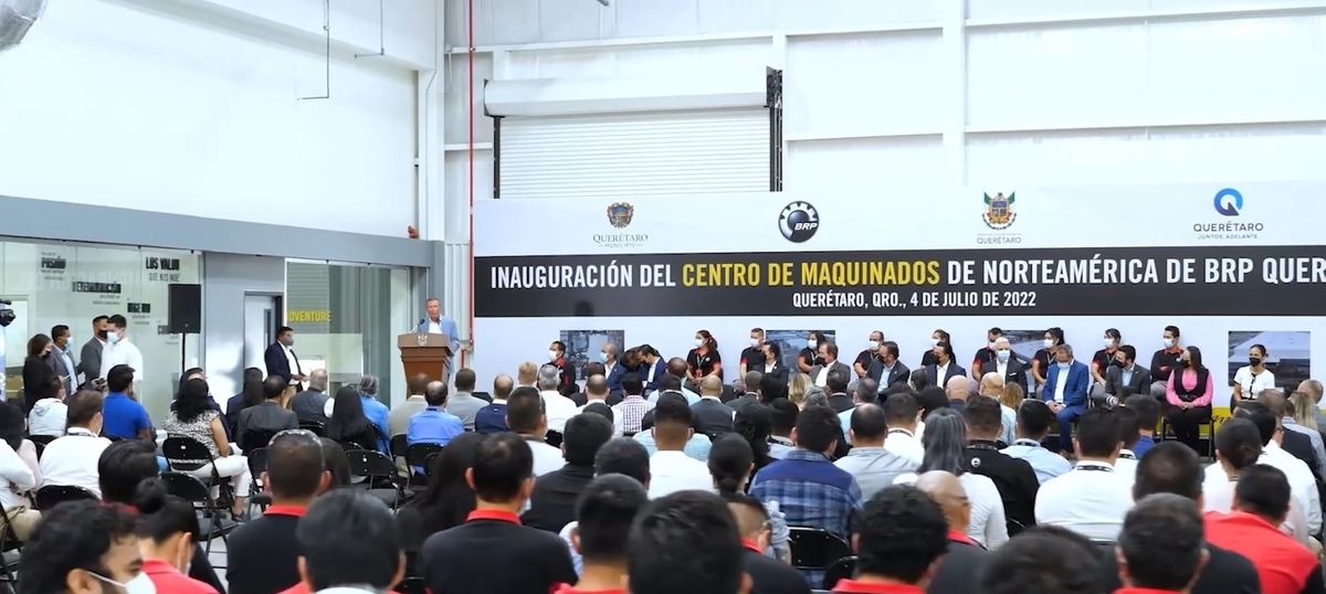 Inauguration ceremony of BRP’s North America Machining Center in Querétaro, with head table, speaker and employees seated in front of the stage