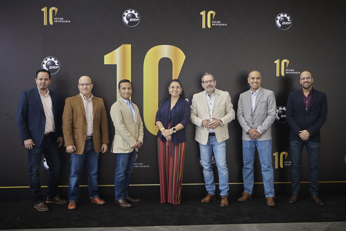 BRP Querétaro leadership team posing in front of a black wall with a golden number 10 and tenth-anniversary logos